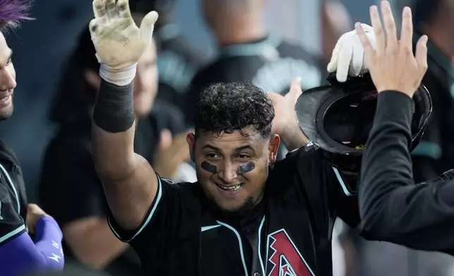 Arizona Diamondbacks' Gabriel Moreno celebrates scoring off a bunt single by Jake McCarthy during the eighth inning of a baseball game against the Los Angeles Dodgers, Tuesday, July 2, 2024, in Los Angeles. (AP Photo/Ryan Sun)