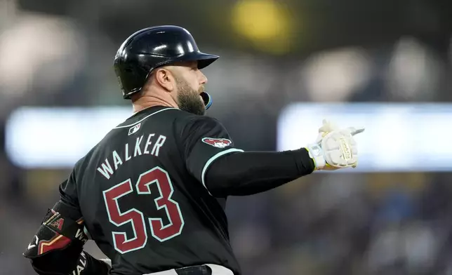 Arizona Diamondbacks' Christian Walker celebrates hitting a two-run home run during the fourth inning of a baseball game against the Los Angeles Dodgers, Tuesday, July 2, 2024, in Los Angeles. (AP Photo/Ryan Sun)