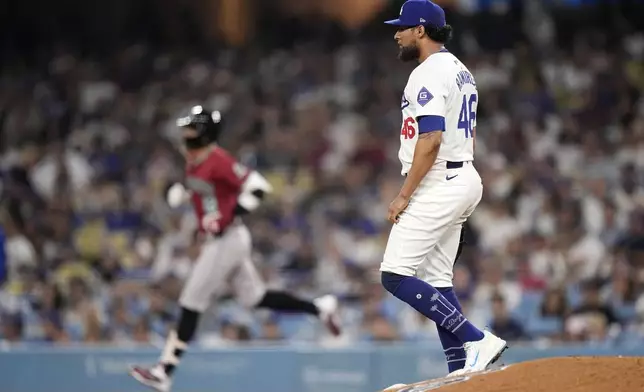 Arizona Diamondbacks' Lourdes Gurriel Jr., left, heads to second after hitting a two-run home run as Los Angeles Dodgers relief pitcher Yohan Ramirez steps off the mound during the sixth inning of a baseball game Wednesday, July 3, 2024, in Los Angeles. (AP Photo/Mark J. Terrill)