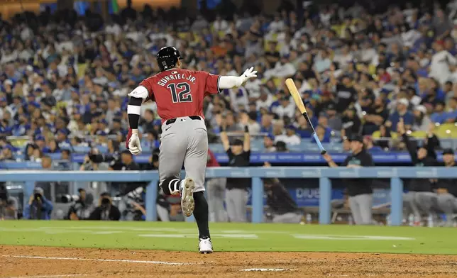 Arizona Diamondbacks' Lourdes Gurriel Jr. drops his bat as he heads to first for a two-run home run during the sixth inning of a baseball game against the Los Angeles Dodgers Wednesday, July 3, 2024, in Los Angeles. (AP Photo/Mark J. Terrill)