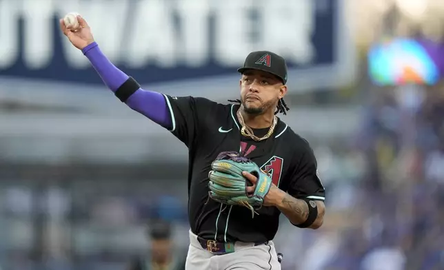 Arizona Diamondbacks second baseman Ketel Marte throws out Los Angeles Dodgers' Gavin Lux at first during the second inning of a baseball game, Tuesday, July 2, 2024, in Los Angeles. (AP Photo/Ryan Sun)