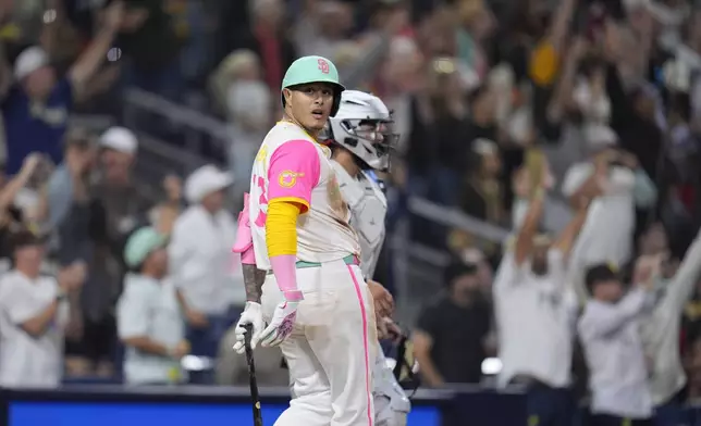 San Diego Padres' Manny Machado celebrates after hitting a game-winning two-run home run during the ninth inning of a baseball game against the Arizona Diamondbacks, Friday, July 5, 2024, in San Diego. The Padres won, 10-8. (AP Photo/Gregory Bull)