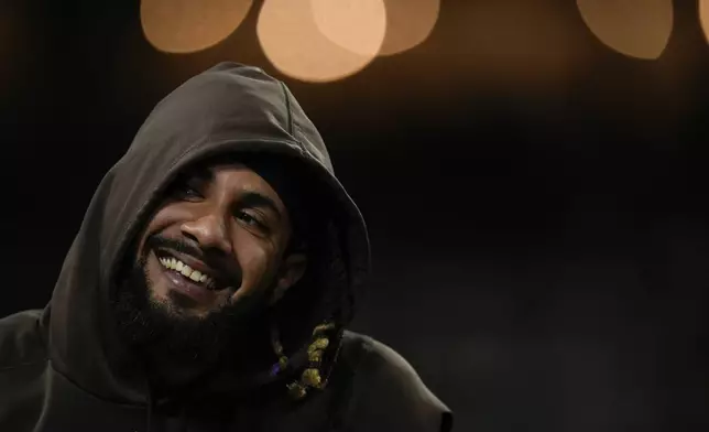 San Diego Padres's Fernando Tatis Jr. laughs as he sits in the dugout during the fifth inning of a baseball game against the Arizona Diamondbacks, Saturday, July 6, 2024, in San Diego. (AP Photo/Gregory Bull)