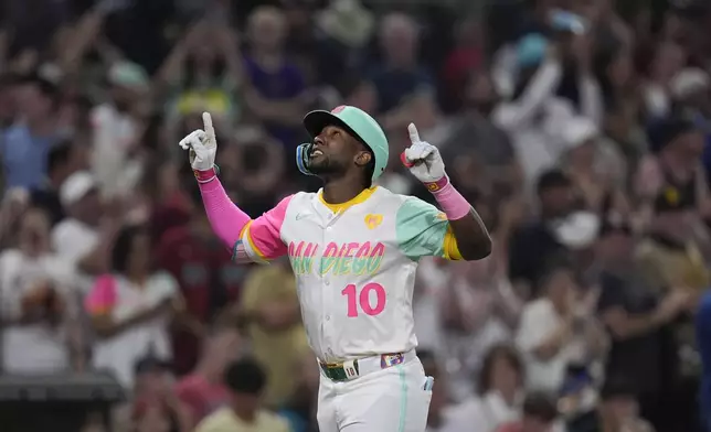 San Diego Padres' Jurickson Profar celebrates after hitting a home run during the ninth inning of a baseball game against the Arizona Diamondbacks, Friday, July 5, 2024, in San Diego. (AP Photo/Gregory Bull)