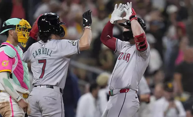 Arizona Diamondbacks' Randal Grichuk, right, celebrates with teammate Corbin Carroll (7) after hitting a two-run home run during the ninth inning of a baseball game against the San Diego Padres, Friday, July 5, 2024, in San Diego. (AP Photo/Gregory Bull)