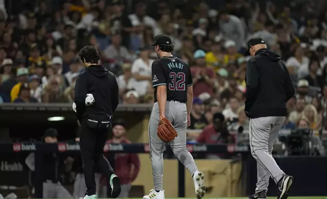 Arizona Diamondbacks starting pitcher Brandon Pfaadt, center, exits after an injury during the fifth inning of a baseball game against the San Diego Padres, Saturday, July 6, 2024, in San Diego. (AP Photo/Gregory Bull)