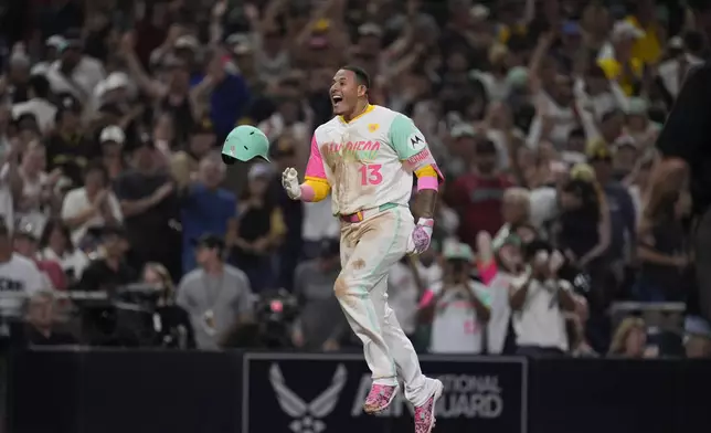 San Diego Padres' Manny Machado celebrates after hitting a game-winning two-run home run during the ninth inning of a baseball game against the Arizona Diamondbacks, Friday, July 5, 2024, in San Diego. The Padres won, 10-8. (AP Photo/Gregory Bull)