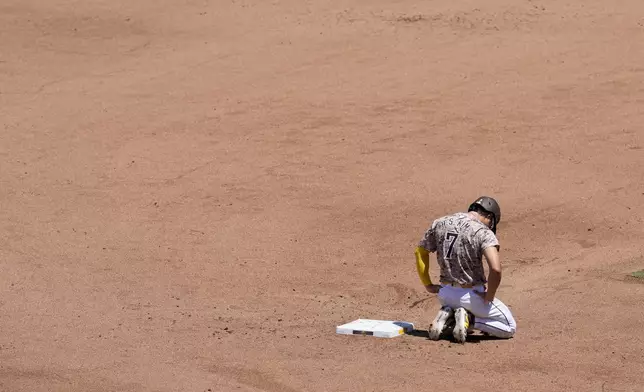 San Diego Padres' Ha-Seong Kim takes a moment after getting tagged out at second base trying to advance from first off a forceout by Luis Campusano during the fifth inning of a baseball game against the Arizona Diamondbacks, Sunday, July 7, 2024, in San Diego. (AP Photo/Gregory Bull)