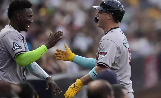 Arizona Diamondbacks' Joc Pederson, right, celebrates with teammate Geraldo Perdomo after hitting a two-run home run during the first inning of a baseball game against the San Diego Padres, Friday, July 5, 2024, in San Diego. (AP Photo/Gregory Bull)