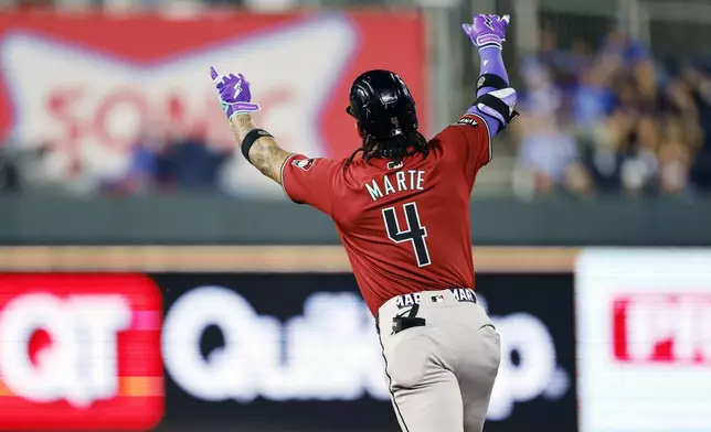 Arizona Diamondbacks' Ketel Marte celebrates hitting a three-run home during the ninth inning of a baseball game against the Kansas City Royals in Kansas City, Mo., Wednesday, July 24, 2024. (AP Photo/Colin E. Braley)