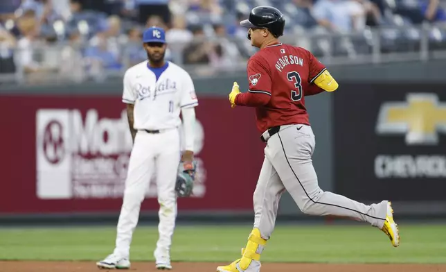 Arizona Diamondbacks Joc Pederson (3) runs by Kansas City Royals third baseman Maikel Garcia (11) after hitting a home run during the fourth inning of a baseball game in Kansas City, Mo., Wednesday, July 24, 2024. (AP Photo/Colin E. Braley)