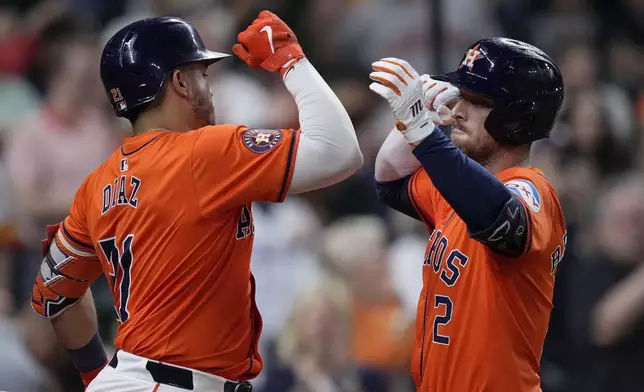 Houston Astros' Alex Bregman, right, celebrates with Yainer Diaz, left, after hitting a solo home run during the third inning of a baseball game against the Los Angeles Dodgers, Friday, July 26, 2024, in Houston. (AP Photo/Kevin M. Cox)