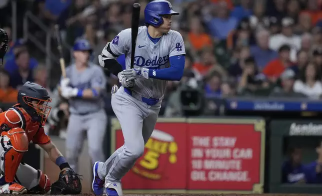 Los Angeles Dodgers designated hitter Shohei Ohtani, right, breaks from the batter's box after a base hit during the eighth inning of a baseball game against the Houston Astros, Friday, July 26, 2024, in Houston. (AP Photo/Kevin M. Cox)