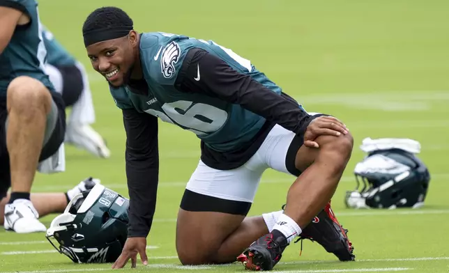 Philadelphia Eagles running back Saquon Barkley stretches during practice at NFL football training camp, Wednesday, July 24, 2024, in Philadelphia. (AP Photo/Chris Szagola)