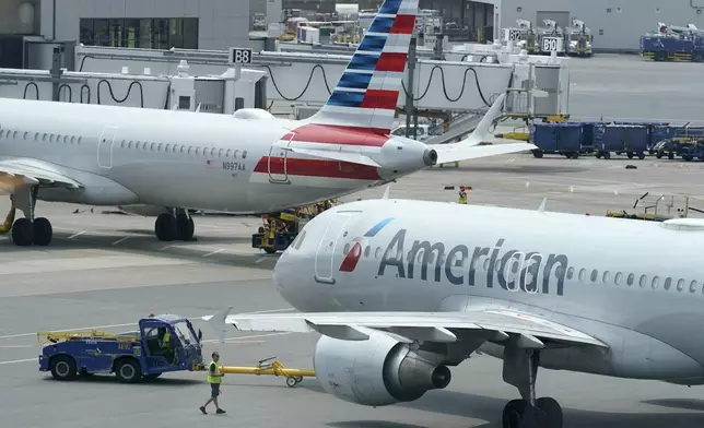 FILE - American Airlines passenger jets prepare for departure, July 21, 2021, near a terminal at Boston Logan International Airport in Boston. (AP Photo/Steven Senne, File)