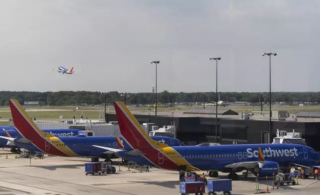 Southwest Airlines planes can be seen on the terminal at Baltimore/Washington International Thurgood Marshall Airport in Baltimore, Friday, July 19, 2024, in Baltimore. (AP Photo/Stephanie Scarbrough, File)