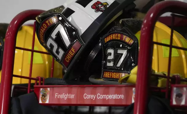 Helmets rest on the locker of firefighter Corey Comperatore at the Buffalo Township Fire Company 27 in Buffalo Township, Pa., Sunday, July 14, 2024. Comperatore was killed during a shooting at a campaign rally for Republican presidential candidate former President Donald Trump in Butler, Pa., on Saturday. (AP Photo/Sue Ogrocki)