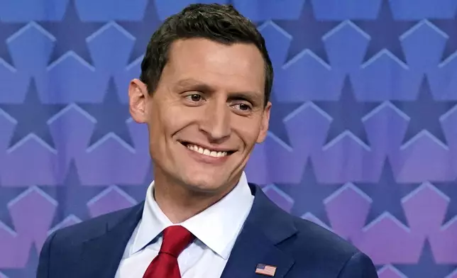 FILE - Then- Republican Senate challenger Blake Masters smiles on stage prior to a televised debate with Arizona Democratic Sen. Mark Kelly and Libertarian candidate Marc Victor in Phoenix, Thursday, Oct. 6, 2022. In a Truth Social post on Saturday night, 27, 2024, former President Donald Trump backed candidates Abraham Hamadeh and Blake Masters — former political allies turned bitter rivals — to represent Arizona’s conservative-leaning 8th Congressional District, praising the pair of Republicans as “two spectacular America First Candidates.” (AP Photo/Ross D. Franklin, FIle)