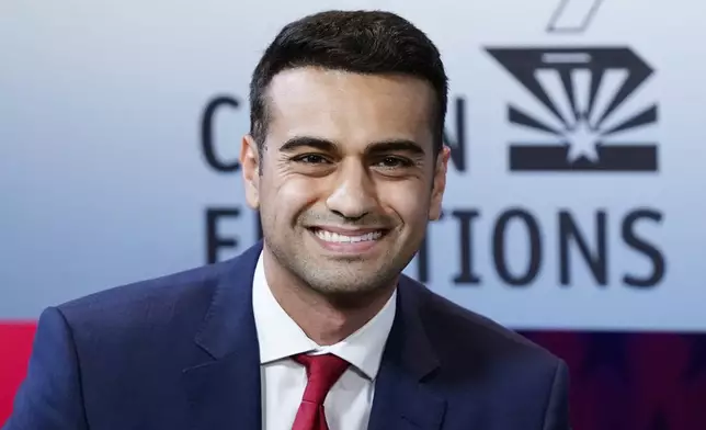 FILE - Then-Republican candidate for Arizona Attorney General, Abraham Hamadeh, smiles prior to a televised debate against Democrat Kris Mayes on Sept. 28, 2022. In a Truth Social post on Saturday night, 27, 2024, former President Donald Trump backed candidates Abraham Hamadeh and Blake Masters — former political allies turned bitter rivals — to represent Arizona’s conservative-leaning 8th Congressional District, praising the pair of Republicans as “two spectacular America First Candidates.” (AP Photo/Ross D. Franklin, File)