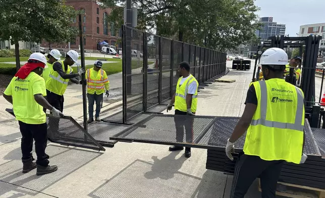 Workers putting up fences near the Republican National Convention location on Wednesday, July 10, 2024, in downtown Milwaukee. (AP Photo/Carrie Antlfinger)