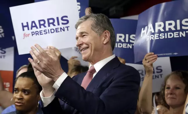 N.C. Governor Roy Cooper applauds one of the other speakers at a press conference, Thursday, July 25, 2024, in Raleigh, N.C. Cooper is one of the people being considered to be likely Democratic presidential candidate Vice President Kamala Harris' running mate. (AP Photo/Chris Seward)