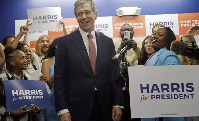 N.C. Governor Roy Cooper smiles as he steps up to speak, speaks at a press conference, Thursday, July 25, 2024, in Raleigh, N.C. Cooper is one of the people being considered to be likely Democratic presidential candidate Vice President Kamala Harris' running mate. (AP Photo/Chris Seward)