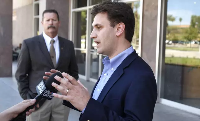 FILE - State Chairman of the Arizona Democratic Party Andrei Cherny, right, talks about the latest involvement of Arizona Republican politicians with the Fiesta Bowl scandal, at the Arizona Capitol, March 30, 2011, in Phoenix. (AP Photo/Ross D. Franklin, File)