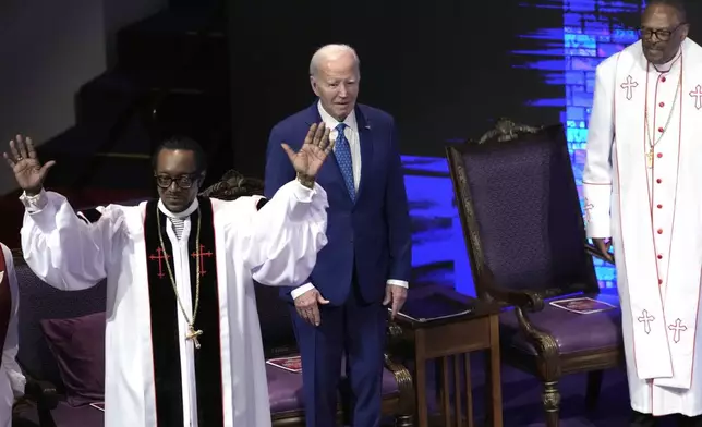 President Joe Biden stands between pastor Dr. J. Louis Felton, left, and Bishop Ernest C. Morris, Sr., at a church service at Mt. Airy Church of God in Christ, Sunday, July 7, 2024, in Philadelphia (AP Photo/Manuel Balce Ceneta)