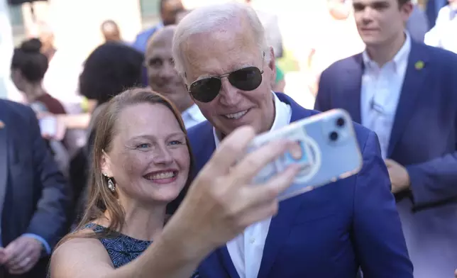 President Joe Biden, right, takes a photo with a supporter at a campaign rally in Harrisburg, Pa., on Sunday, July 7, 2024. (AP Photo/Manuel Balce Ceneta)