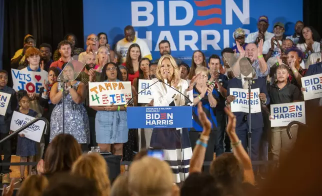 First lady Jill Biden, center, speaks during an event at American Legion Post 111 as she campaigns for her husband, President Joe Biden, Monday, July 8, 2024, in Seminole Heights, Fla. (Dylan Townsend/Tampa Bay Times via AP)