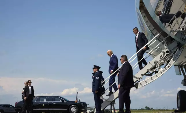 President Joe Biden, second right, exits Air Force One on arrival to Detroit Metropolitan Wayne County Airport in Detroit, Friday July 12, 2024, for a campaign event. (AP Photo/Jacquelyn Martin)