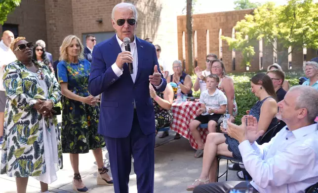 President Joe Biden speaks to supporters as first lady Jill Biden, second from left, listens at a campaign rally in Harrisburg, Pa., on Sunday, July 7, 2024. (AP Photo/Manuel Balce Ceneta)