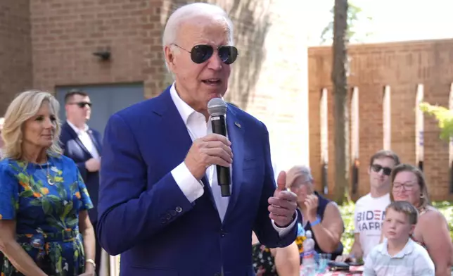 President Joe Biden speaks to supporters as first lady Jill Biden, left, looks on at a campaign rally in Harrisburg, Pa., on Sunday, July 7, 2024. (AP Photo/Manuel Balce Ceneta)