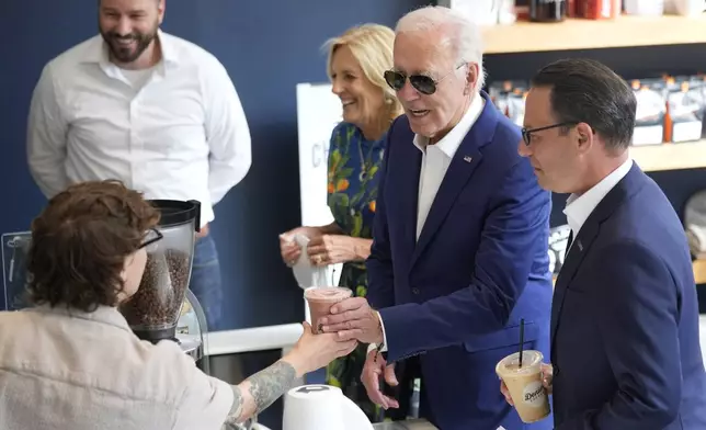 Pennsylvania Gov. Josh Shapiro, from right, President Joe Biden and first lady Jill Biden visit Denim Coffee after a campaign event in Harrisburg, Pa., on Sunday, July 7, 2024. (AP Photo/Manuel Balce Ceneta)