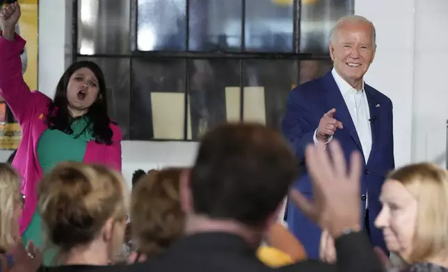 President Joe Biden, right, speaks as Rep. Haley Stevens, D-Mich., left, cheers during a visit to Garage Grill &amp; Fuel Bar during a campaign stop in Northville, Mich., Friday July 12, 2024. (AP Photo/Jacquelyn Martin)