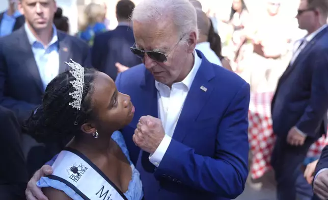 President Joe Biden, right, greets Kahlia Brown, Miss Black Teen Pennsylvania, at a campaign rally in Harrisburg, Pa., on Sunday, July 7, 2024. (AP Photo/Manuel Balce Ceneta)