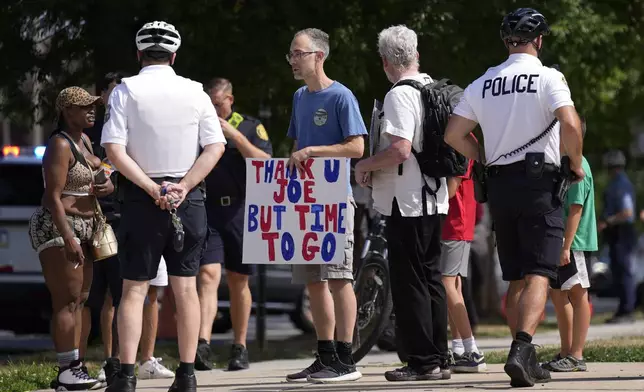 A protester holds a sign ahead of President Joe Biden's visit to Mt. Airy Church of God in Christ, Sunday, July 7, 2024, in Philadelphia. (AP Photo/Matt Rourke)