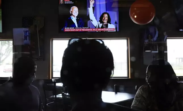 Diners watch news of President Joe Biden dropping out of the 2024 race for the White House at They Say Restaurant in Harper Woods, Mich., Sunday, July 21, 2024. (AP Photo/Paul Sancya)