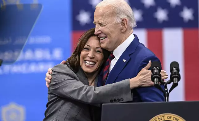 FILE - Vice President Kamala Harris embraces President Joe Biden after a speech on healthcare in Raleigh, N.C., March. 26, 2024. President Joe Biden dropped out of the 2024 race for the White House on Sunday, July 21, ending his bid for reelection following a disastrous debate with Donald Trump that raised doubts about his fitness for office just four months before the election. (AP Photo/Matt Kelley, File)