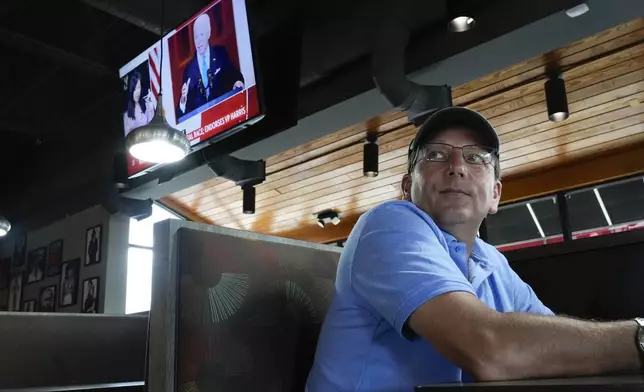 Joe DeFrain watches news of President Joe Biden dropping out of the 2024 race for the White House at They Say Restaurant in Harper Woods, Mich., Sunday, July 21, 2024. (AP Photo/Paul Sancya)