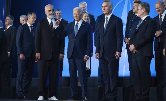 FILE - President Joe Biden pumps his fist during a family photo at the NATO Summit, Wednesday, July 10, 2024, in Washington. Biden’s withdrawal from the U.S. presidential race on Sunday, July 21, injects greater uncertainty into the world at a time Western leaders are grappling with two complicated wars in Ukraine and Gaza, a more assertive China in Asia and the rise of the far-right in Europe that threatens to erode democratic norms. (AP Photo/Evan Vucci, File)