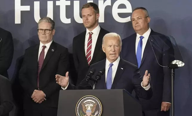 FILE - Britain's Prime Minister Keir Starmer, left, looks on as U.S. President Joe Biden speaks, where he introduced Ukrainian President Volodymyr Zelenskyy during an event on the Ukraine Compact at the NATO Summit at the Walter E. Washington Convention Center, in Washington, Thursday, July 11, 2024. Biden's withdrawal from the U.S. presidential race injects greater uncertainty into the world. (Stefan Rousseau/Pool Photo via AP, File)