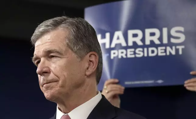 N.C. Governor Roy Cooper listens to one of the other speakers at a news conference, Thursday, July 25, 2024, in Raleigh, N.C. Cooper is one of the people being considered to be likely Democratic presidential candidate Vice President Kamala Harris' running mate. (AP Photo/Chris Seward)