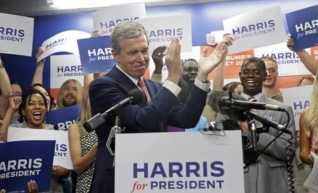 N.C. Governor Roy Cooper claps as he speaks at a news conference, Thursday, July 25, 2024, in Raleigh, N.C. Cooper is one of the people being considered to be Democratic presidential candidate Vice President Kamala Harris' running mate. (AP Photo/Chris Seward)