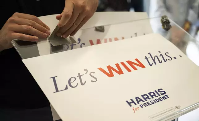 Posters for Vice President Kamala Harris' campaign are taped to a podium during a campaign event on Thursday, July 25, 2024 in Philadelphia. (AP Photo/Joe Lamberti)