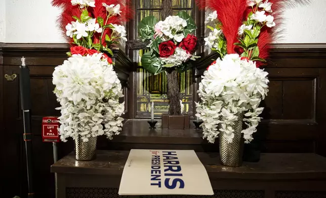 Leftover posters for Vice President Kamala Harris' campaign are surrounded by flowers during a campaign event on Thursday, July 25, 2024 in Philadelphia. (AP Photo/Joe Lamberti)