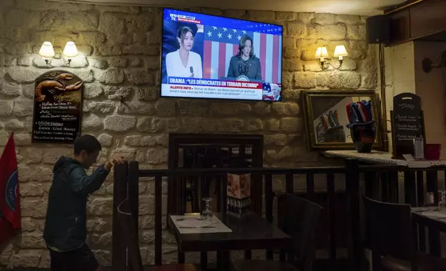 A television broadcasts the news that Vice President Kamala Harris was endorsed by President Joe Biden after he dropped out of the 2024 race for the White House, Sunday, July 21, 2024., in Paris.