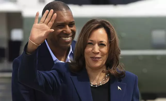 Vice President Kamala Harris waves before boarding Air Force Two as she departs on campaign travel to Milwaukee, Wisc., Tuesday, July 23, 2024 at Andrews Air Force Base, Md. (Kevin Mohatt/Pool via AP)