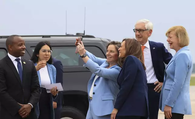 Vice President Kamala Harris poses for a selfie with Wisconsin Lt. Gov. Sara Rodriguez as Sen. Tammy Baldwin, D-Wis., right, and Wisconsin Gov. Tony Evers, watch, after Harris arrived in Milwaukee, Tuesday, July 23, 2024. (Kevin Mohatt/Pool via AP)