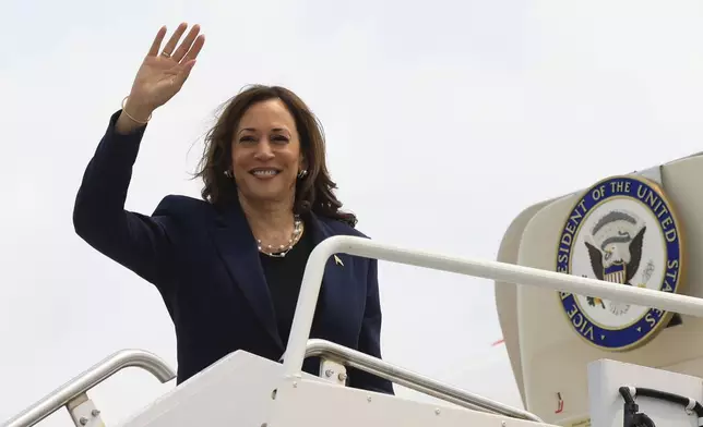 Vice President Kamala Harris waves as she boards Air Force Two following a campaign event, in Milwaukee, Wis., Tuesday, July 23, 2024. (Kevin Mohatt/Pool via AP)